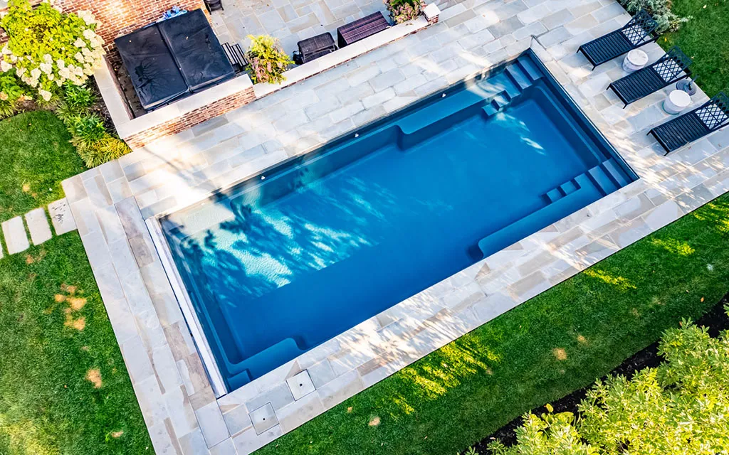 Drone view of a Leisure Pools inground fiberglass pool Premium fiberglass pool installations for Sarasota