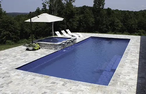 Leisure Pools The Grand rectangular fiberglass composite pool for lounging, installed by Leisure Pools Sarasota
