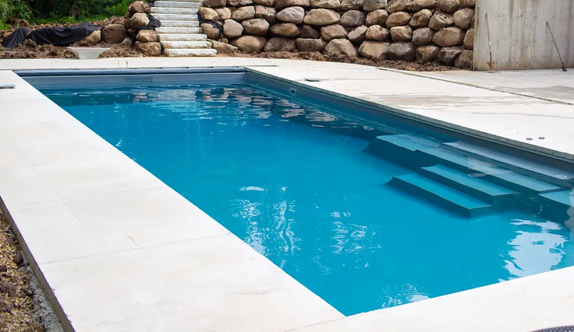 Leisure Pools The Grand rectangular fiberglass pool side view by Leisure Pools Sarasota